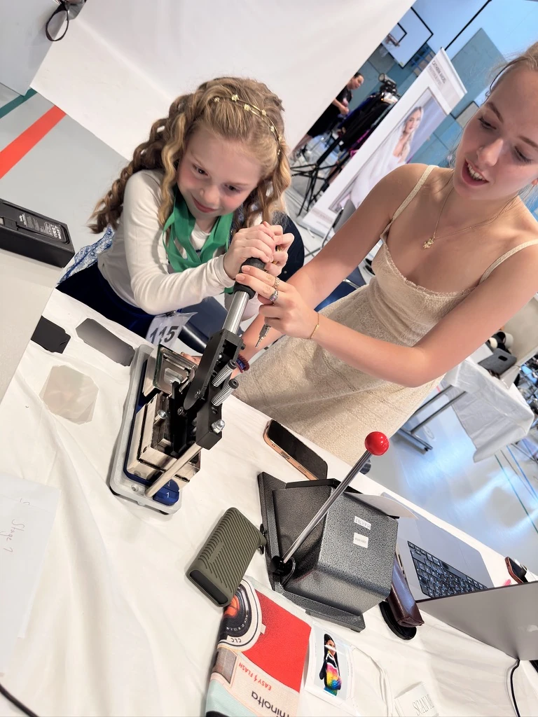 Two Irish dancers hand-pressing a photo magnet together